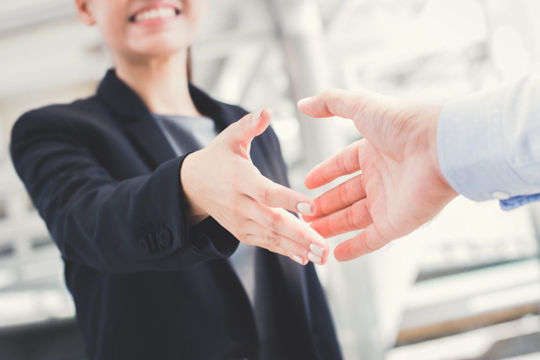  A businessperson in a suit is interviewing a potential new employee.