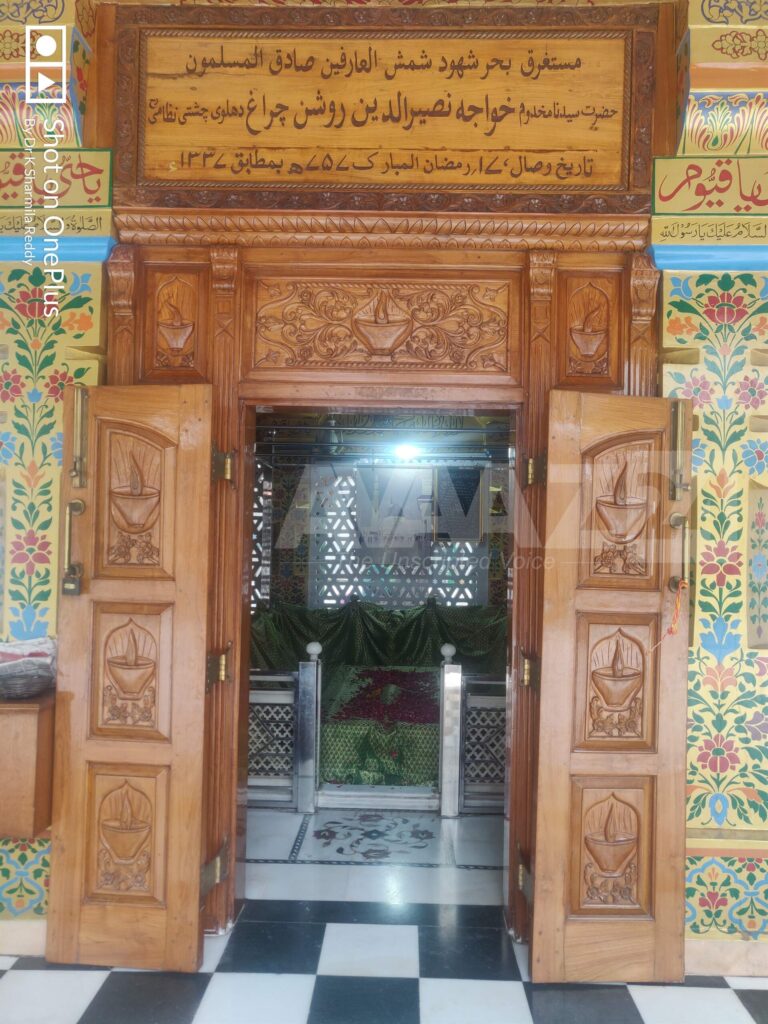 Wooden door with carved lamps