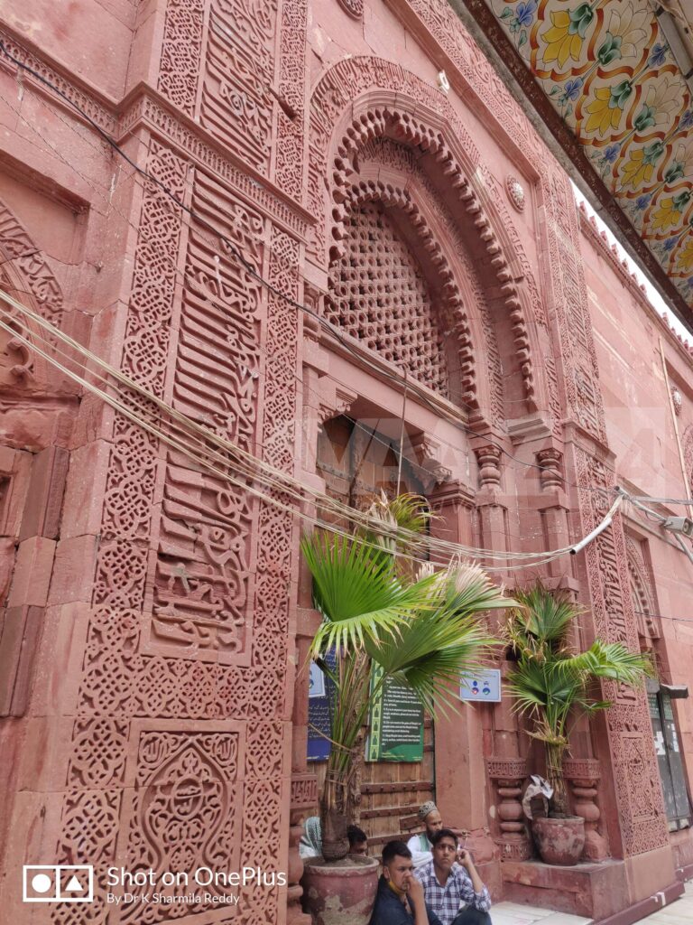 Beautifully carved Quranic Ayats on the red sandstone walls of Jamat Khana Mosque