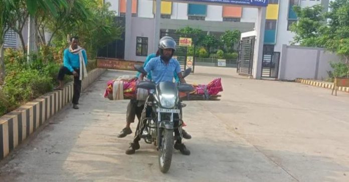 man carries mothers body on bike