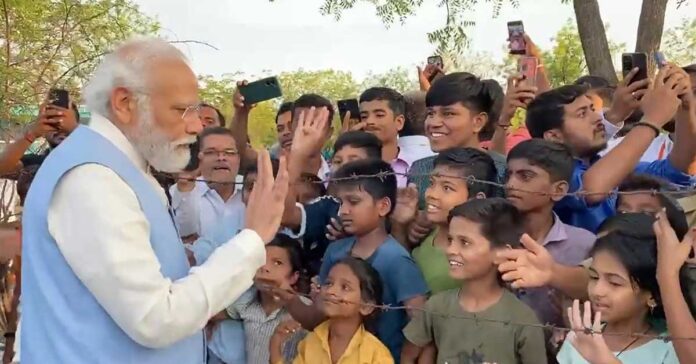 modi meeting kids behind wire fence